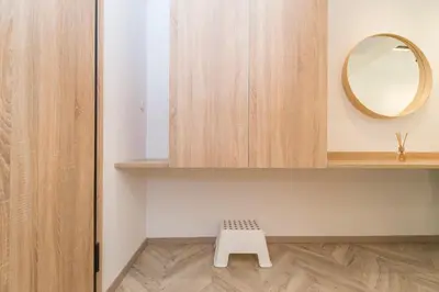 a bathroom with a mirror and a white stool at Lovely studio 1' from Attiki metro station in Athens