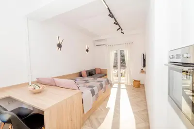a living room with a couch and a table at Lovely studio 1' from Attiki metro station in Athens