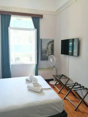 a bedroom with a bed with towels on it at Elegant apartment under the Acropolis in Athens