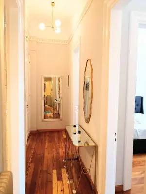 a room with a table and a mirror on the wall at Elegant apartment under the Acropolis in Athens