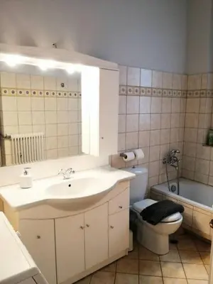 a bathroom with a sink and a toilet and a tub at Elegant apartment under the Acropolis in Athens