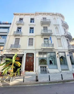 a large white building on the side of a street at Elegant apartment under the Acropolis in Athens