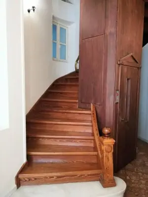 a wooden staircase with a wooden door in a room at Elegant apartment under the Acropolis in Athens