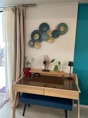 a wooden table with four plates on a wall at ZEN Neapoli Penthouse Apartment in Athens