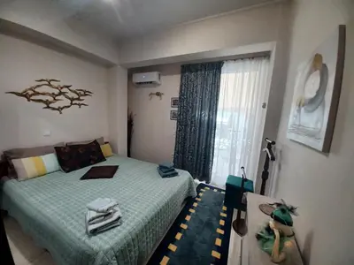 a small bedroom with a bed and a window at ZEN Neapoli Penthouse Apartment in Athens