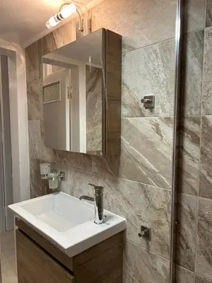a bathroom with a white sink and a shower at ZEN Neapoli Penthouse Apartment in Athens