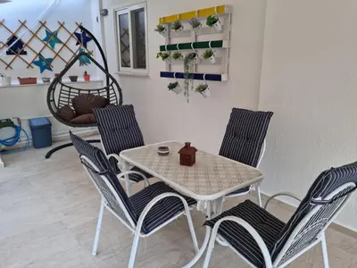 a table and chairs in a living room at ZEN Neapoli Penthouse Apartment in Athens