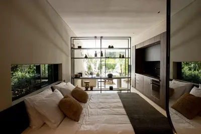 a large white bed in a room with a large window at Vouliagmeni Apartments 18 in Athens