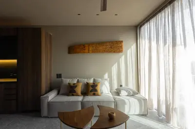 a living room with a white couch and a table at Vouliagmeni Apartments 18 in Athens