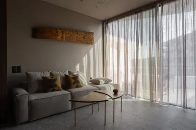 a living room with a couch and a large window at Vouliagmeni Apartments 18 in Athens