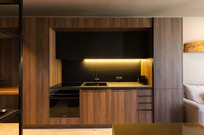 a kitchen with a sink and a flat screen tv at Vouliagmeni Apartments 18 in Athens