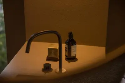 a bottle of alcohol sitting on a bathroom sink at Vouliagmeni Apartments 18 in Athens