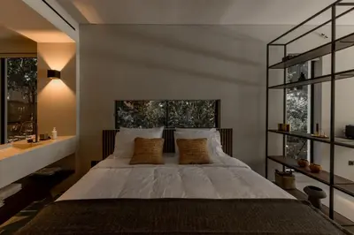 a bedroom with a large bed and two windows at Vouliagmeni Apartments 18 in Athens