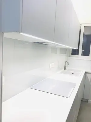 a kitchen with white cabinets and a sink at Acropolis Flat in Athens