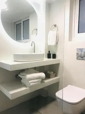 a bathroom with a sink and a mirror at Acropolis Flat in Athens