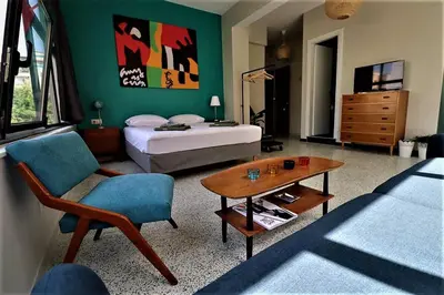 a bedroom with a bed and a table and a chair at Central urban studio A in Athens