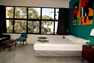 a bedroom with a bed and a large window at Central urban studio A in Athens