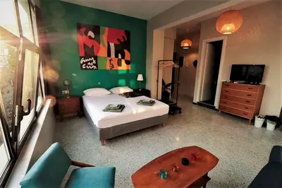 a bedroom with a bed and a couch and a television at Central urban studio A in Athens