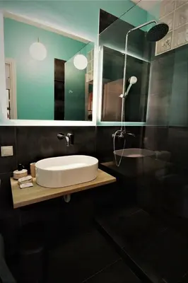 a bathroom with a sink and a shower and a mirror at Central urban studio A in Athens