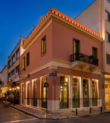 a building on the corner of a street at night at Urban Tales in Athens