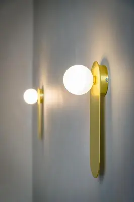 a pair of lights on a wall in a room at Urban Tales in Athens
