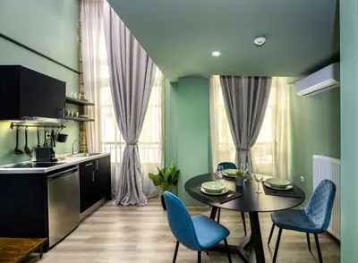 a kitchen and dining room with a table and chairs at Urban Tales in Athens