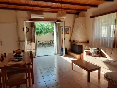 a living room with a couch and a table at Anna's House in Anavissos
