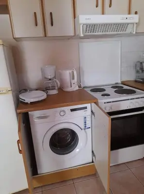a kitchen with a washing machine and a stove at Anna's House in Anavissos