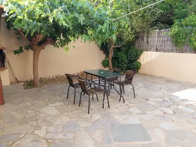 a table and chairs sitting on a stone patio at Anna's House in Anavissos