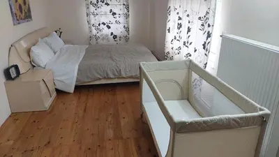 a small bedroom with a bed and a wooden floor at Anna's House in Anavissos