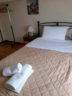 a bedroom with a bed with two towels on it at Anna's House in Anavissos
