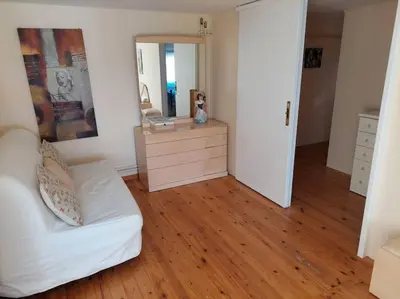 a living room with a white couch and a mirror at Anna's House in Anavissos