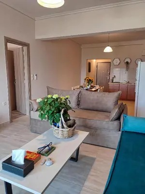 a living room with a couch and a table at Seaview-Apartments in Palaiá Fókaia