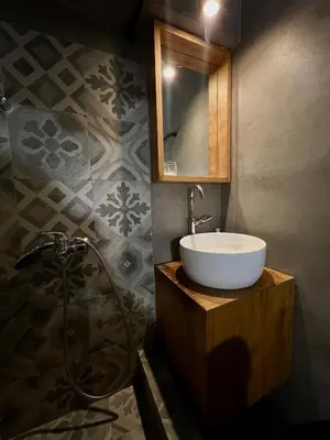 a bathroom with a sink and a mirror and a shower at New apartment at Athenian Riviera in Athens