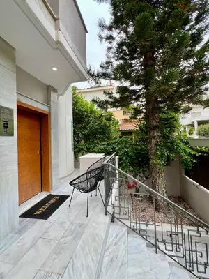 a staircase leading to a house with a tree at New apartment at Athenian Riviera in Athens