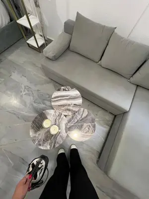 a person standing in front of a couch with a table at New apartment at Athenian Riviera in Athens