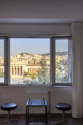 a room with two chairs and a table in front of a window at A Truly WOW Experience for Every Guest. THE place in Athens