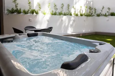 a jacuzzi tub in a room with plants at LUX&EASY Athens Downtown Residences in Athens