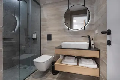 a bathroom with a toilet and a sink and a mirror at LUX&EASY Athens Downtown Residences in Athens