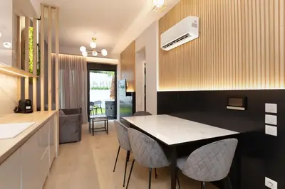 a kitchen and dining room with a table and chairs at LUX&EASY Athens Downtown Residences in Athens