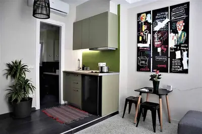 a kitchen with a sink and a table in a room at Central urban studio B in Athens