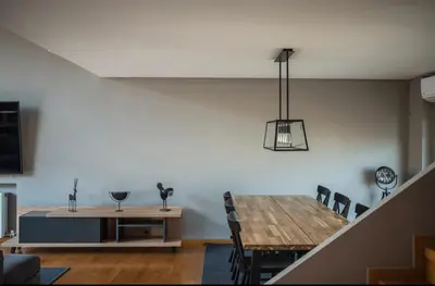 a living room with a dining room table and a dining room at Minimal New Loft next to Subway in Athens