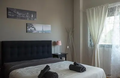 a bedroom with a bed with two black towels on it at Minimal New Loft next to Subway in Athens