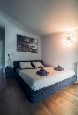 a bedroom with a bed with two towels on it at Minimal New Loft next to Subway in Athens
