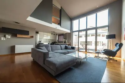 a living room with a couch and a table at Minimal New Loft next to Subway in Athens