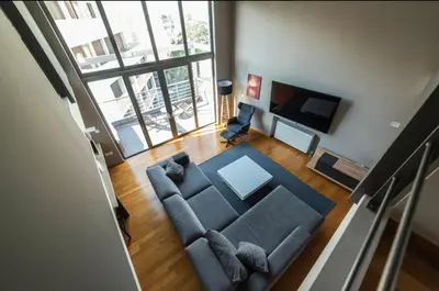 an overhead view of a living room with a couch and a television at Minimal New Loft next to Subway in Athens