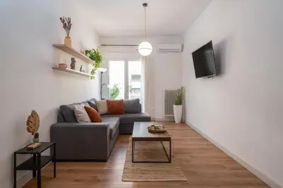 a living room with a couch and a table at ☆Kalimarmaro 3BD Apt For Max Fun & Comfortability☆ in Athens