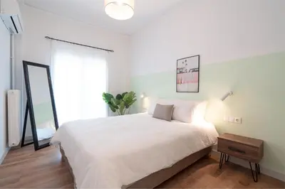a bedroom with a white bed and a large window at ☆Kalimarmaro 3BD Apt For Max Fun & Comfortability☆ in Athens