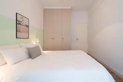 a white bedroom with a large white bed at ☆Kalimarmaro 3BD Apt For Max Fun & Comfortability☆ in Athens