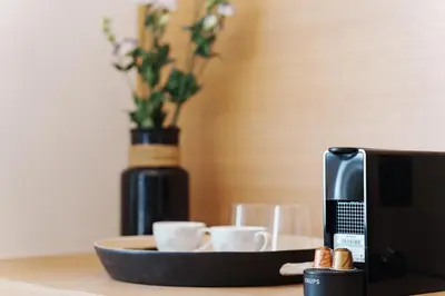 a table with cups and a tray with a microwave at Agora Athens Suites in Athens